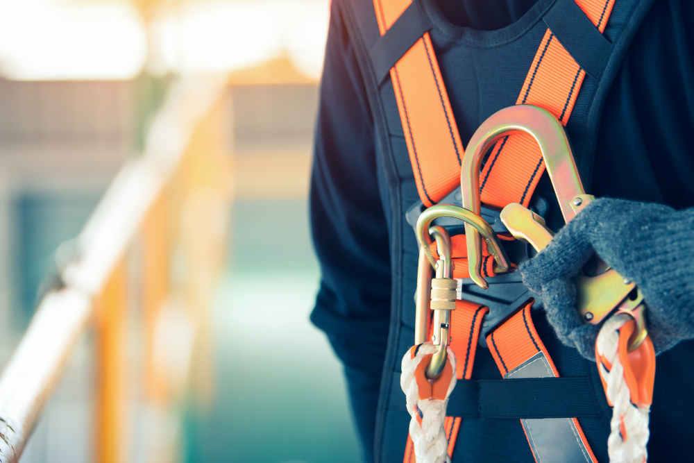 A construction worker is standing on a job site, fully equipped with appropriate personal protective equipment (PPE) such as a hard hat, safety goggles, and high-visibility clothing. This image highlights the importance of construction safety and occupational safety measures to protect construction workers from potential hazards.